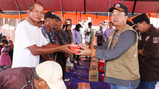 Plh Sekdaprov Kalsel, Muhammad Syarifuddin menyerahkan bantuan untuk korban banjir di Desa Kali Besar, Kecamatan Kurau, Kabupaten Tanah Laut. Foto: wasaka.kalselprov.go.id